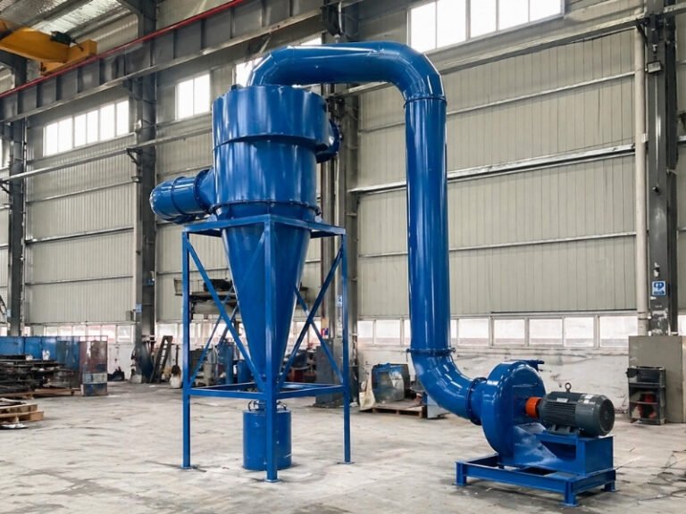 Blue cyclone dust collector system with connected fan and ductwork in an industrial workshop