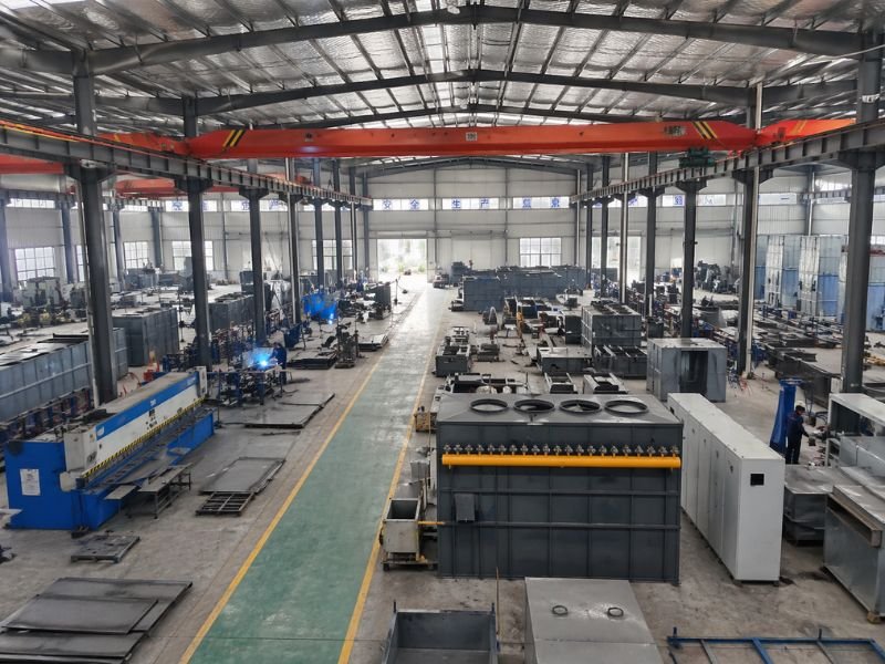 Dust collector factory workshop with steel fabrication, welding, and equipment assembly production line