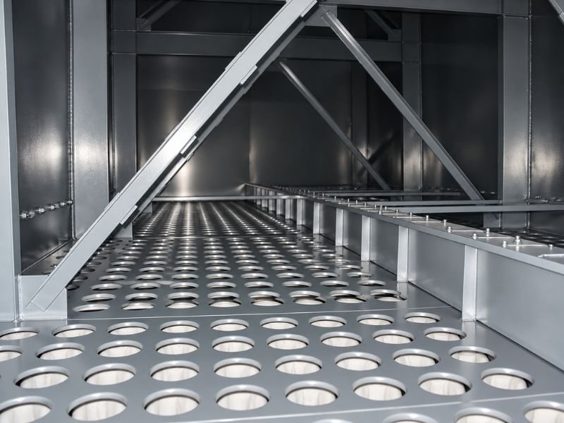 Internal protective coating and tube sheet inside an industrial baghouse dust collector